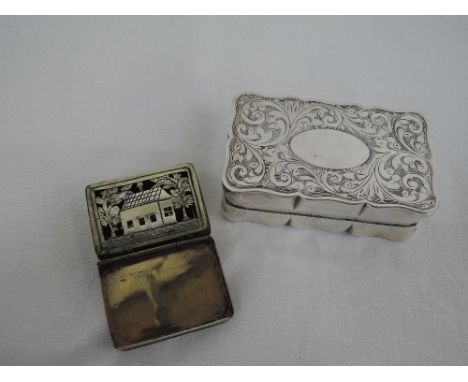 A silver hinged patch box of shaped rectangular form having engraved scroll decoration to top and base, plain cartouche and g