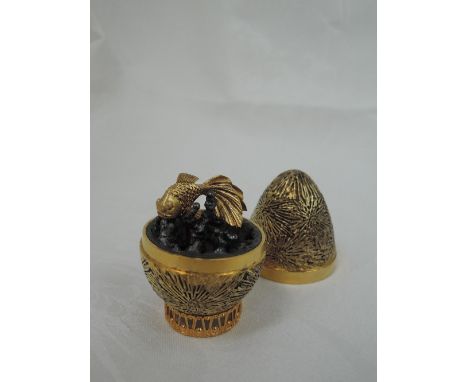 A cased Stuart Devlin 1971 silver gilt limited edition surprise Easter egg having a textured star burst exterior opening to r