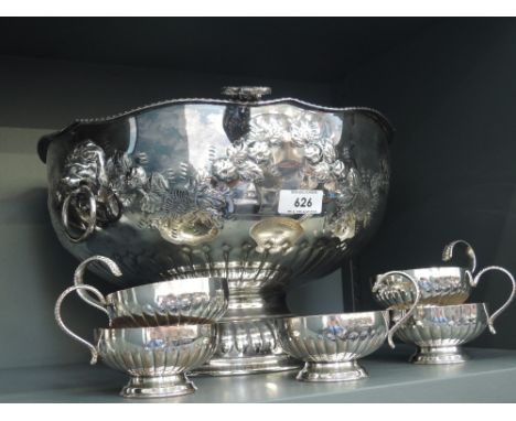 A Sheffield plate punch bowl having lion mask handles and embossed floral swag decoration, a Kings pattern punch ladle and fi