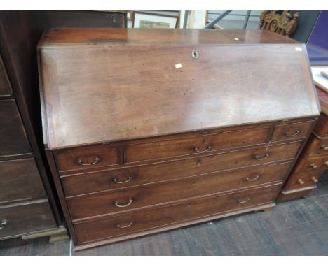 An early 19th Century mahogany bureau having fall flap and fitted interior over 3 frieze drawers and 3 long drawers on bracke