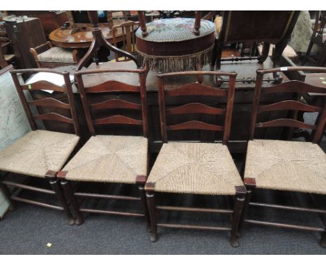 A set of four stained frame vernacular chairs having bow ladder backs, later seagrass seats on turned frames