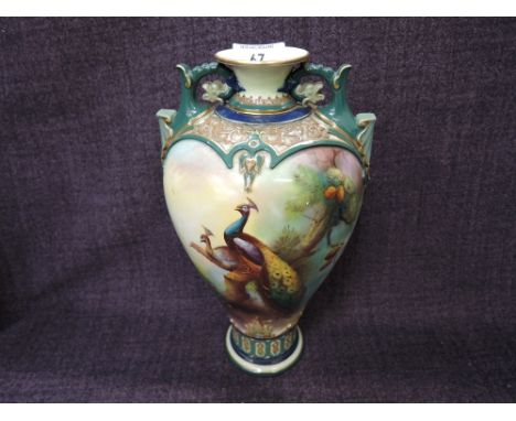 A Royal Worcester vase having pictorial Peacock decoration by C V White, on gilt heightened blue/green ground, marked to base