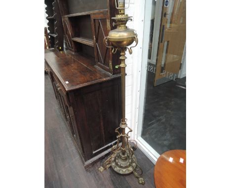 A late Victorian brass oil lamp converted to electric of Art Nouveau scroll design