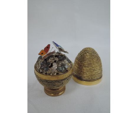 A cased Stuart Devlin 1976 silver gilt limited edition surprise Easter egg having a textured exterior opening to reveal a pai