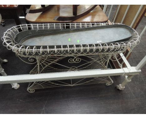 A Victorian style white painted wirework planter