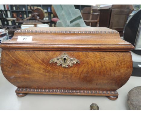 A Victorian pollard oak tea caddy of casket form having brass lion mask handles and bun feet