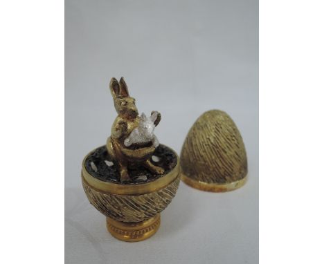 A cased Stuart Devlin 1975 silver gilt limited edition surprise Easter egg having a textured exterior opening to reveal a tre