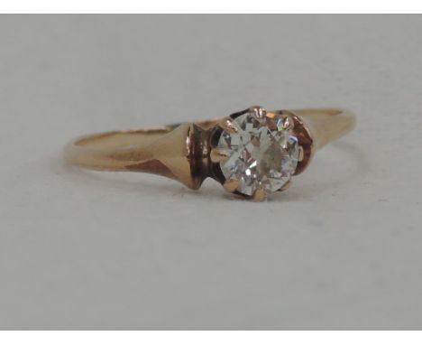 A lady's dress ring having a diamond solitaire, approx .45ct in a claw mount to butt end shoulders on a rose metal loop, bear