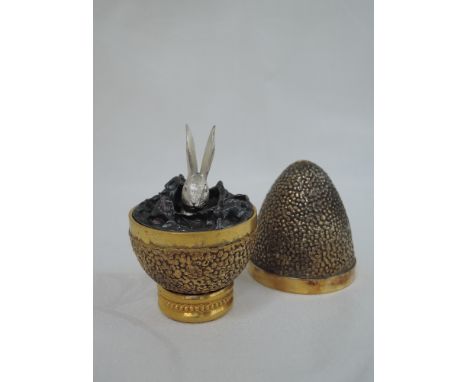 A cased Stuart Devlin 1970 silver gilt limited edition surprise Easter egg having a textured exterior opening to reveal a tre