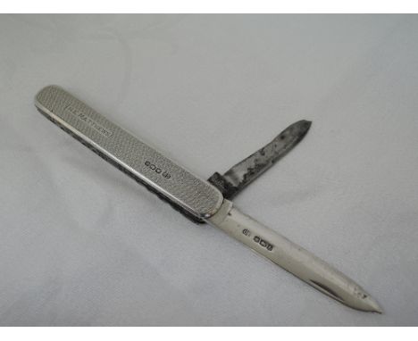 A silver pen knife having a silver blade, steel blade and missing blade, cover having engine turned decoration and inscribed 