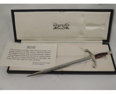 A cased letter opener by Wilkinson sword modelled as a 15th century crusader's sword having etched decoration to blade HM sil