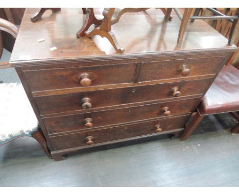 An early 19th century oak chest of 2 short and 3 long cockbeaded drawers on bracket feet