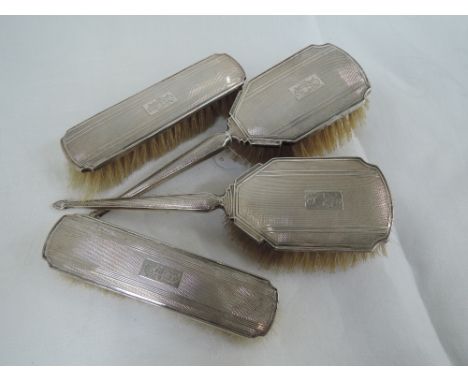 Four HM silver brushes having engine turned decoration and monogram to cartouches, Birmingham 1947,  Charles S Green & Co Ltd
