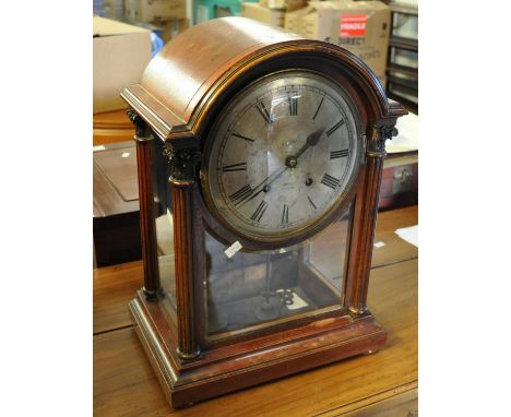 Late 19th/early 20th Century mahogany arch topped two train mantel clock with silvered face and Roman numerals, key and pendu
