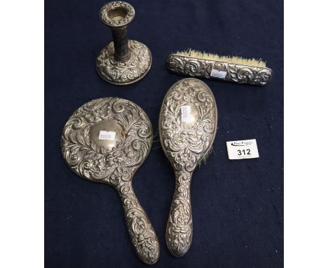 Bag containing silver dressing table items to include two brushes, a hand mirror, and a small single candlestick.(B.P. 21% + 