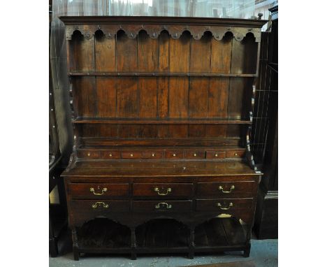 Early 19th Century Swansea valley style oak two stage pot board dresser, the moulded cornice above shaped frieze with fitted 