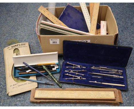 Box of vintage instruments to include compass set, plastic and wooden rulers, transparent bevelled edge French curves, pencil