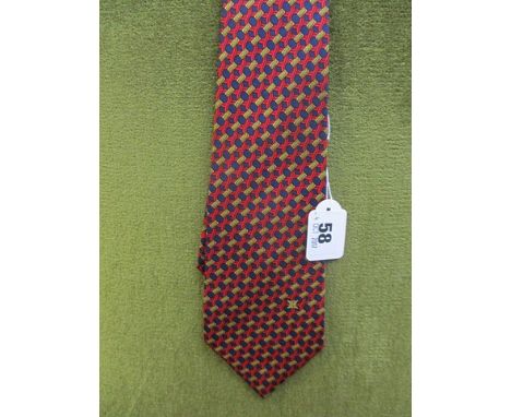 A Celine, Paris, silk tie having a red background with a blue dot and gold coloured bar pattern