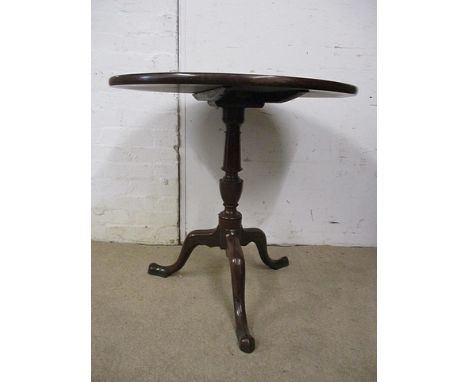 A George III mahogany pedestal table having a tip top over a baluster turned column, raised on a tripod base, 27 1/2 h, 28 di