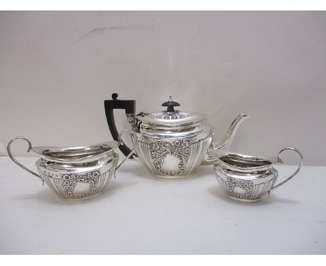 A late Victorian silver three piece teaset by Joseph Gloster, Birmingham 1897 with floral and scrolled, embossed decoration, 