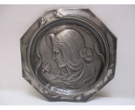An Art Nouveau octagonal pewter dish decorated with the head and shoulder portrait of a woman in profile with flowing hair, 8