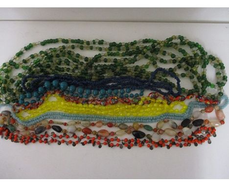 A quantity of vintage beads and necklaces to include an extra long string of 1920s necklace of green, yellow and clear beads