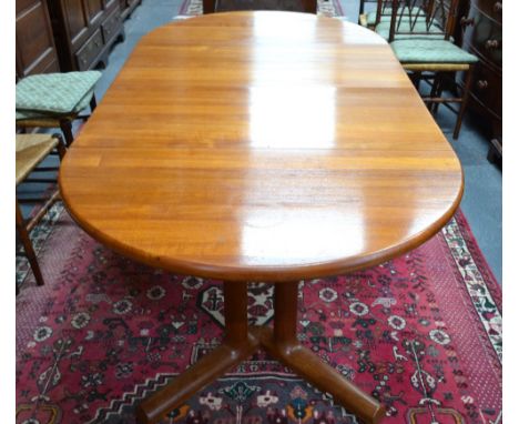 A Danish design teak extending dining table by Dyrlund, Denmark circa 1970's/80's, the circular top raised on a quadrupled ba