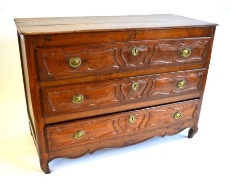 An 18th century French provincial oak commode, the moulded edge top over three long drawers having moulded cartouche panels, 