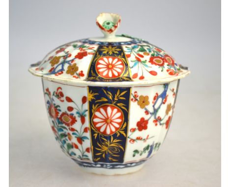 A Worcester underglaze blue and enamel decorated, circular bowl and domed cover with flower finial, decorated with alternate 