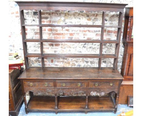 An 18th/19th century oak dresser, the upper part with four tiers over three frieze drawers and a pot shelf