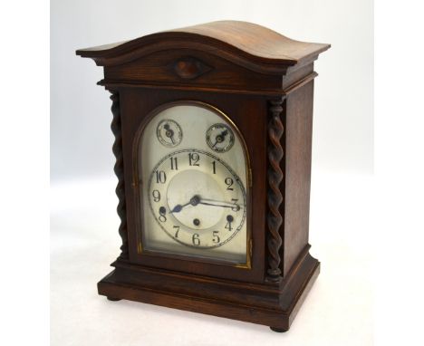  A German walnut cased mantel clock, the eight-day three train movement striking the quarters and hours on five tubular rods 