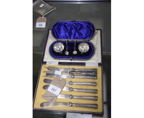A cased pair of silver salts on ball feet, and six cased silver handled tea knives, along with a silver handled cake fork. 