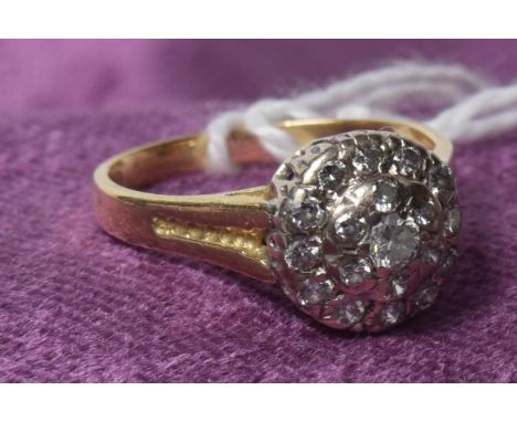 An 18ct gold diamond cluster ringThe brilliant cut diamond within a similarly cut diamond double surround, hallmarks for Lond