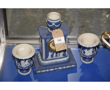 A Wedgwood blue jasperware mantel clock along with two campana shaped urns. (3)Condition:Clock 25cm highurns - 11cm highClock