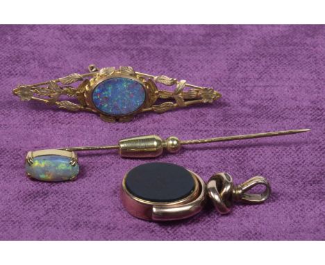 A selection of jewelleryTo include an opal stickpin, an opal triplet brooch and a 9ct gold hardstone spinner fob, total weigh