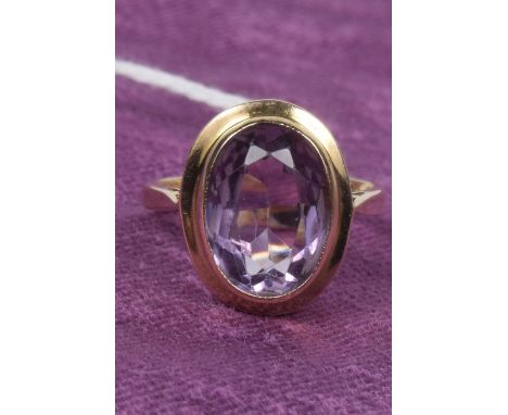 A 9ct gold amethyst single stone ringThe oval shape amethyst collet with tapered shoulders, hallmarks for Birmingham, ring si