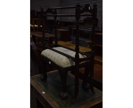 An Edwardian inlaid mahogany towel rail and a mahogany dressing stool on ball and claw feet. 