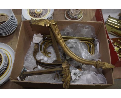 A pair of gilt metal leaf cast curtain pole supports, a pair of gilt metal and porcelain flower head tie backs, and a collect