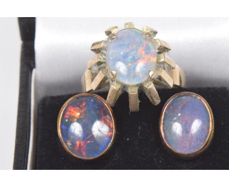 An opal triplet ringThe oval opal triplet cabochon within a tapered surround, stamped 14k, together with a pair of opal tripl