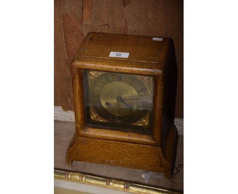 An Early 20th Century bracket clock with gilt dial and scumbled hardwood case. 