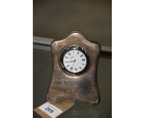 A hallmarked silver easal mantle time piece, the white dial signed R Carr, England. 