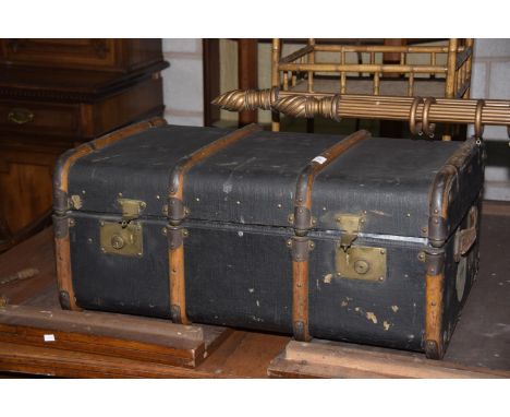 A Vintage travel trunk with removable tray and applied stickers. 
