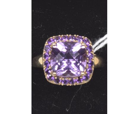 A 9ct gold amethyst cluster ringThe square shape amethyst within a circular shape amethyst surround, hallmarks for Birmingham