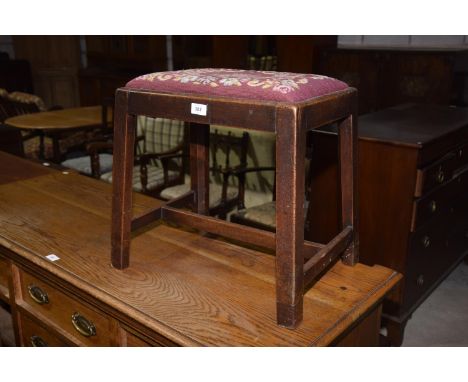 A 19th Century mahogany stool, having a drop in seat on chamfered legs of square section. 