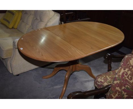 An Ercol light elm oval extending kitchen table.111cm extends to 150cmHeight 72cmWidth 98cm. 