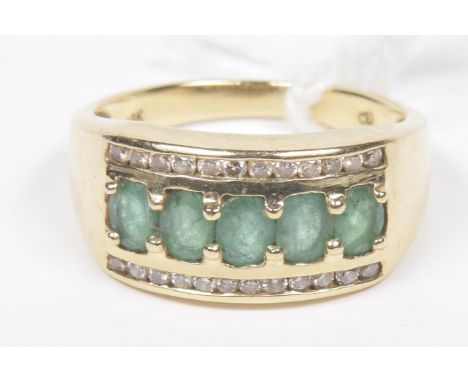 An emerald and diamond dress ringThe oval shape emerald line with brilliant cut diamond sides, estimated total diamond weight