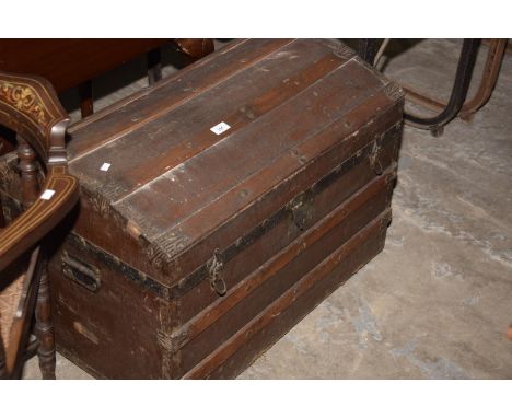 A domed and slatted leather trunk. 