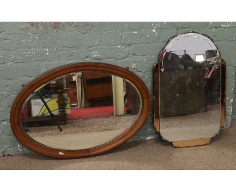 A Victorian mahogany oval framed bevel edge wall mirror, along with an Art Deco example.