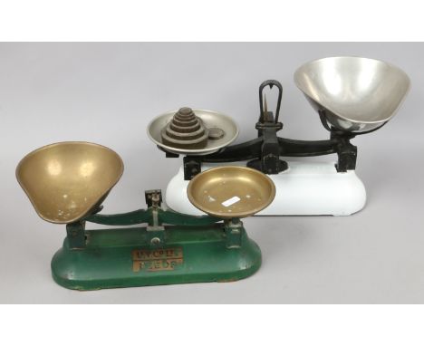 A set of enamel Avery scales and weights along with another set of scales.
