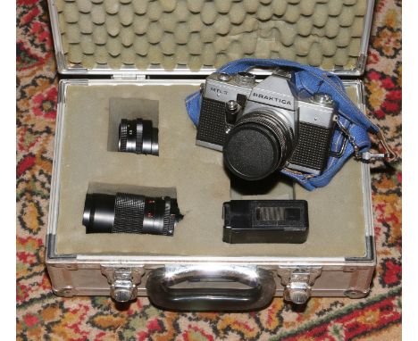 A cased Praktica MTL3 camera with lenses and flash.